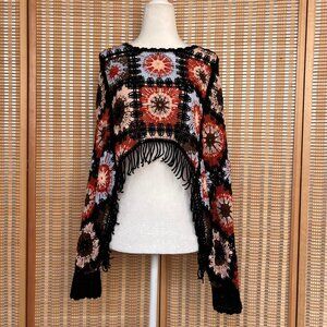 Crochet poncho style cropped sweater with fringe and open sleeves